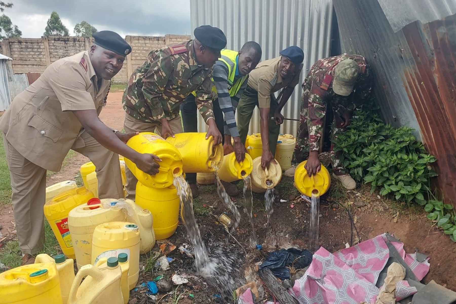 File image of police officers destroying illicit alcohol.